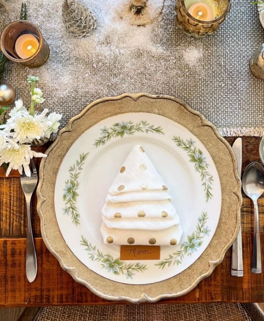 Close-up of styled napkin on a holiday table as part of an elegant Christmas tablescape.