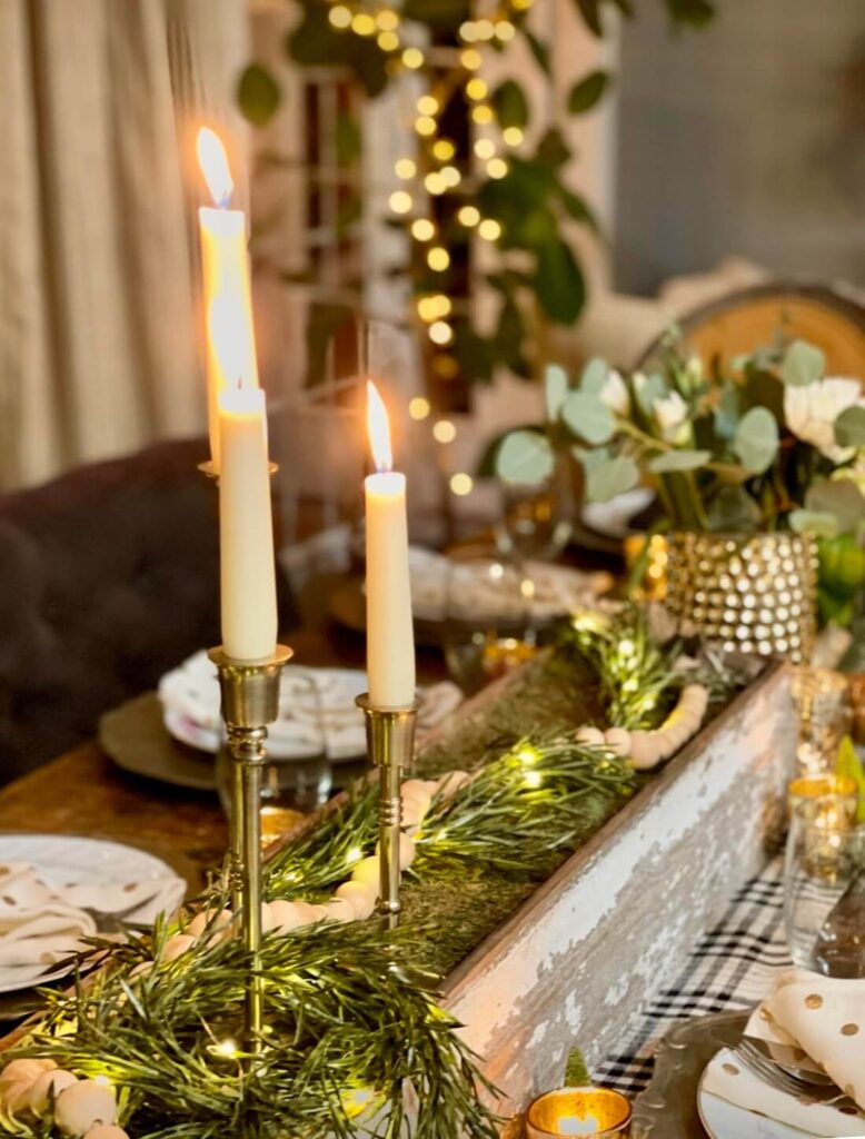 Tall centerpiece on a Christmas tablescape adding vertical interest to a styled holiday table.